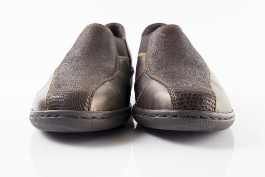 Pair of brown leather shoes on white background, isolated product, top view.