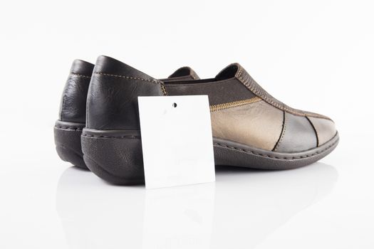 Pair of brown leather shoes on white background, isolated product, top view.