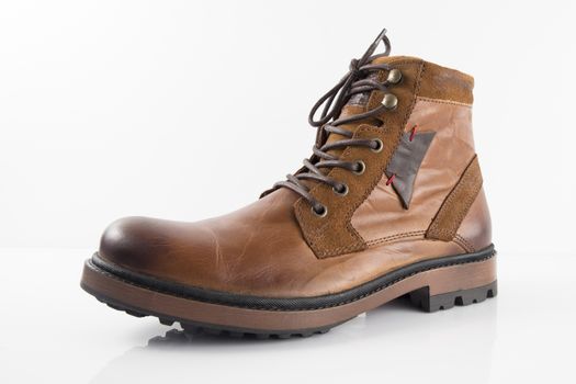 Pair of brown leather boots on white background, isolated product, top view.