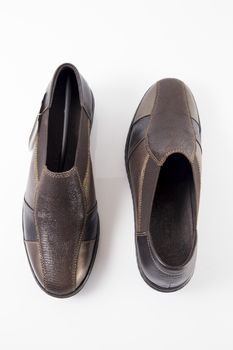 Pair of brown leather shoes on white background, isolated product, top view.