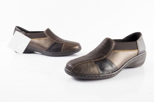 Pair of brown leather shoes on white background, isolated product, top view.