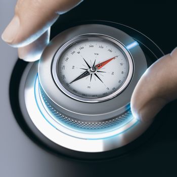 Close up of a man using modern compass for orientation purpose. Composite image between a hand photography and a 3D background.