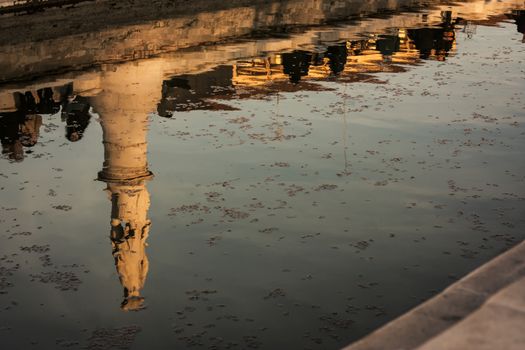 A beautiful water reflection of a historical monument in a typical Italian city. Artistic photo.