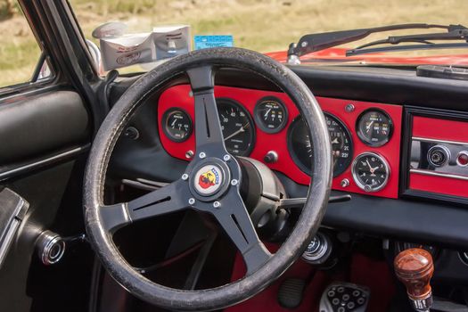 Interior of a Fiat Abarth historic resumption of the dashboard details and the sports steering wheel. A beautiful Italian historical cars.