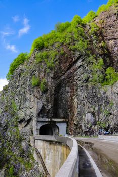 View of the road and the tunnel through the mountain, selective focus