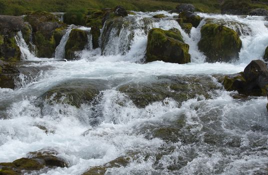 Water Splashing Between Stones in Waterfall