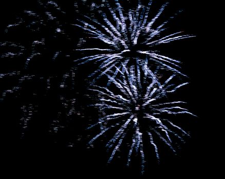 Blue flash and sparks from fireworks isolated on black background.