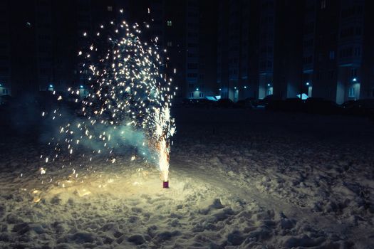 Burning Mini Fireworks in the Snow on a Winter Evening.