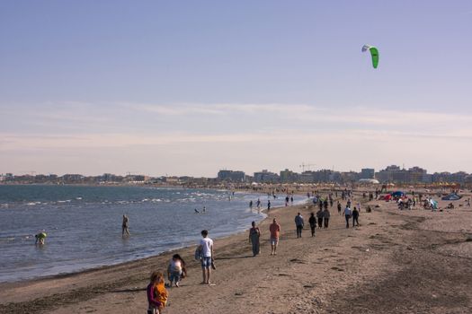 North Italy's beach filled with tourists and locals to enjoy the day and the mild climate.