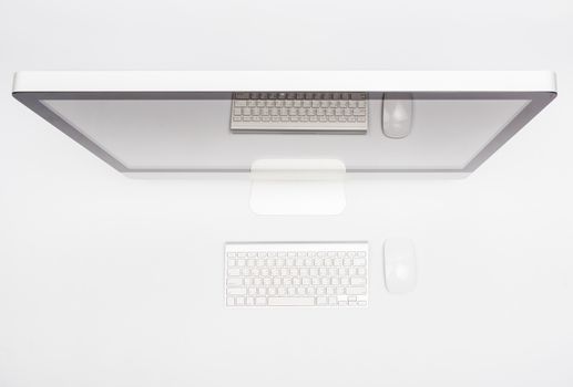 Top view monitor computer retina display, mouse, keyboard and blank screen on white table