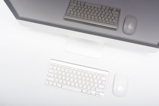 Top view monitor computer retina display, mouse, keyboard and blank screen on white table