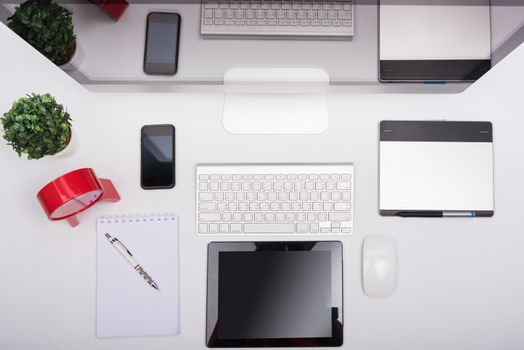 Top view Office monitor computer retina display, mouse, keyboard, mobile phone, tablet and blank screen on white table