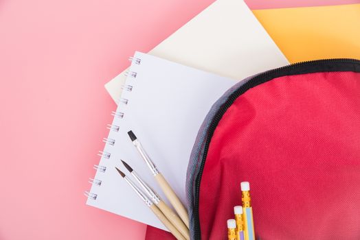 Top view Red bag backpack for education children on pink background back to school concept