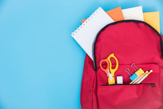 Top view Red bag backpack for education children on blue background back to school concept