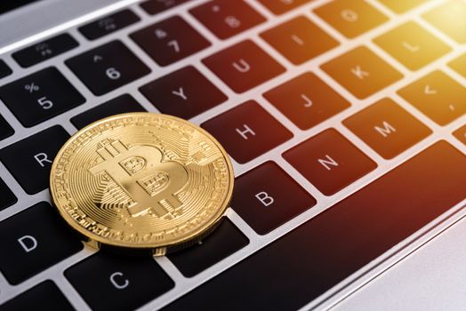 Coin, virtual golden bitcoin money on keyboard laptop computer,