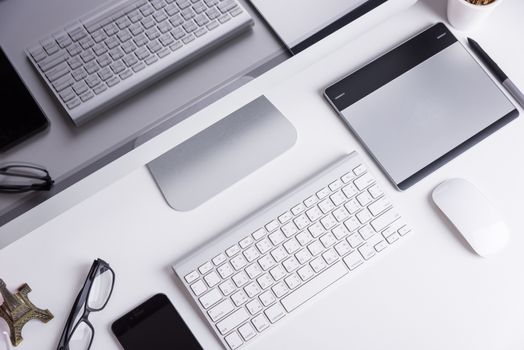 Office Computer on white wooden table and mobile phone