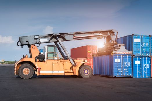 Forklift truck lifting Cargo containers in shipping dock yard for import,export logistic industrial
