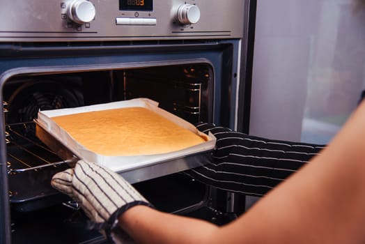 Hands of baker woman female bakery holding dough bread fresh on front oven