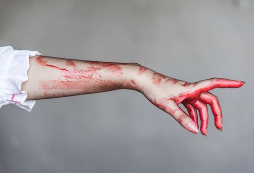Ghost woman or Zombie stretching bloody hands, halloween concept