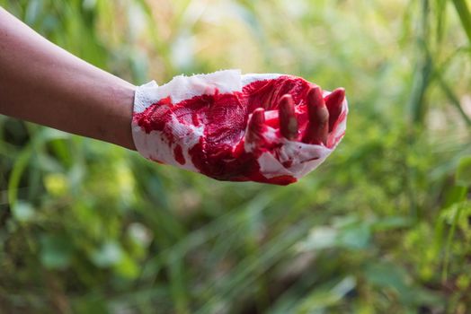 Medicine bandage with very bloody red injury man hand after accident