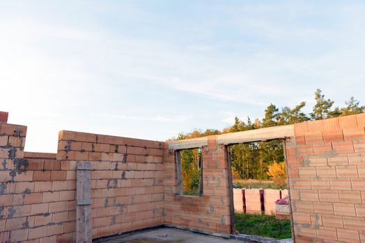 Interior of a Unfinished Red Brick House Walls under Construction without Roofing.