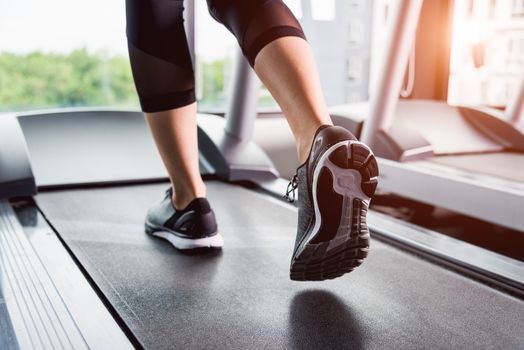 Woman running exercise on track treadmill at fitness gym