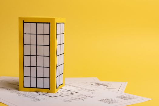 Yellow paper block of flats on yellow background paper. Minimalistic and simple concept, style. Copy space. Horizontal orientation.