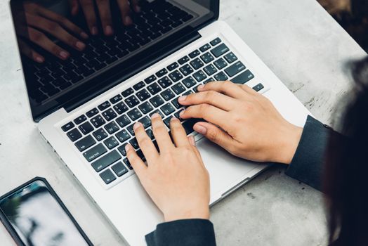 Business woman using his computer laptop on The desk is surrounded by nature