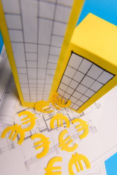 Paper skyscrapers , euro money, house projects plan and blueprints on blue background paper. Minimalistic and simple concept, style. Vertical orientation. View from above.