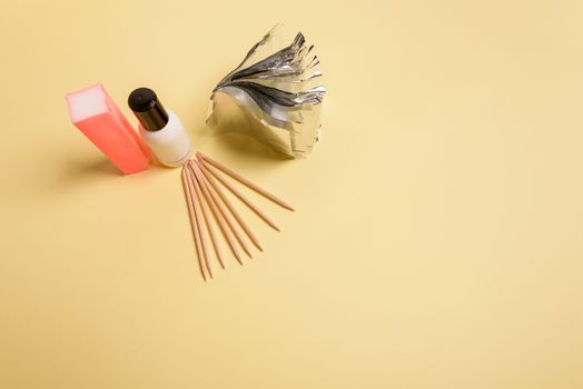 Hybrid manicure removal kit. The procedure for removing varnish from nails in progress