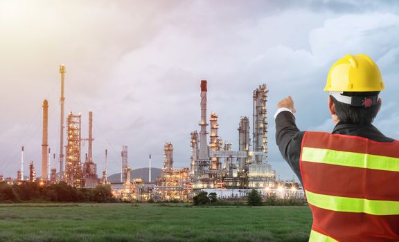 Petrochemical engineering man with white safety helmet standing in oil refinery building structure petrochemical industry