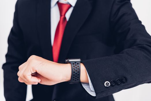 Business man wearable and he seeing smart watch on hand, the smartwatch is modern technology design isolated on white background