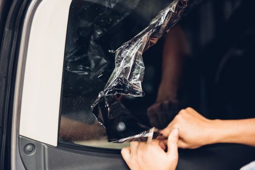 Specialist worker service peeling old film from window car
