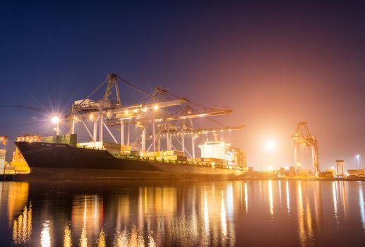 Containers loading by crane on morning dark, Trade Port , Shipping , transport