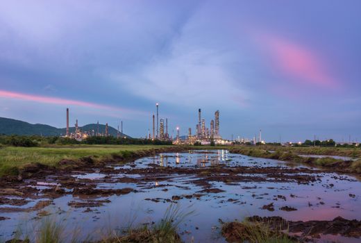 Oil petrochemical refinery plant at sunset twilight