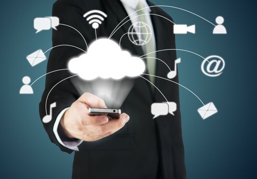 Businessman hand holding smart phone cloud connectivity on drak background