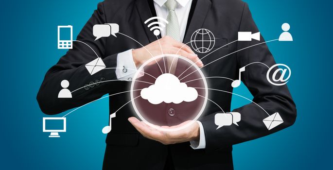 Businessman holding cloud computing network on blue background