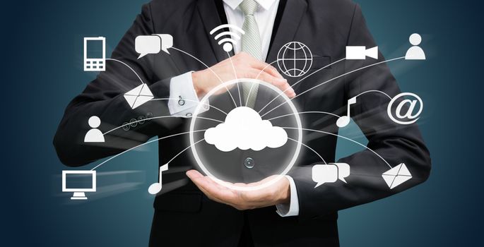 Businessman holding cloud computing network on dark background