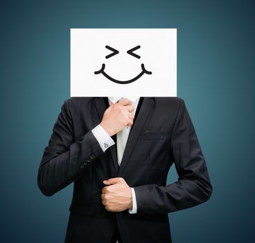 Businessman standing white paper happy smile face holding front of head on dark background