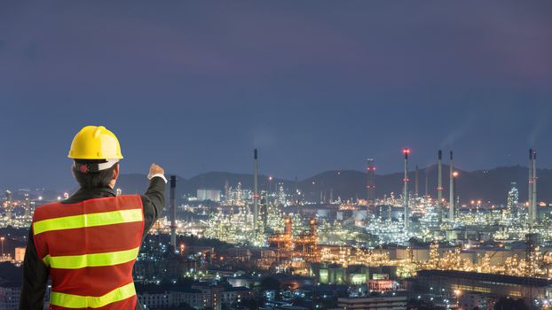 Petrochemical engineering man with white safety helmet standing in oil refinery building structure petrochemical industry