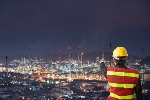 Petrochemical engineering man with white safety helmet standing in oil refinery building structure petrochemical industry