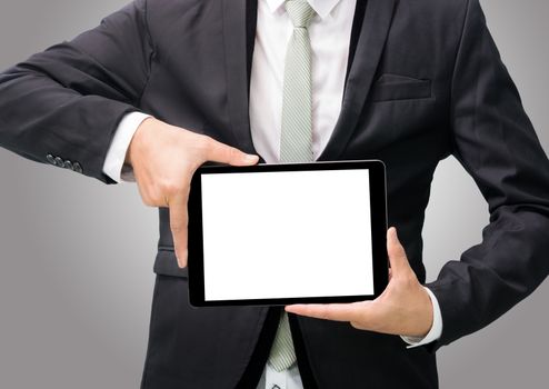 Businessman standing posture hand holding blank tablet isolated on over gray background