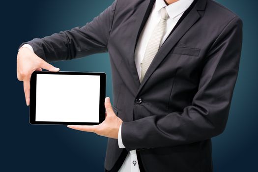 Businessman standing posture hand holding blank tablet isolated on dark background