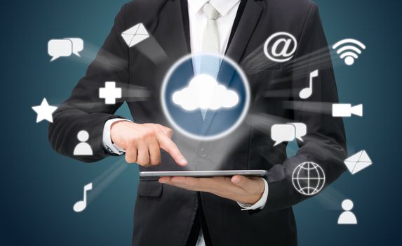Businessman hand holding tablet cloud connectivity on drak background