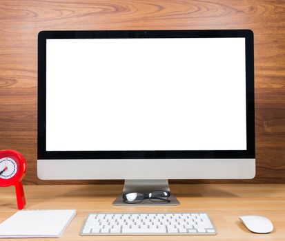Office monitor computer, mouse on wood table and wooden wall background