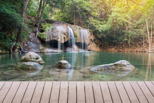 Wooden plank and background with Waterfall in Erawan Park