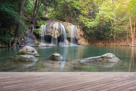 Wooden plank and background with Waterfall in Erawan Park