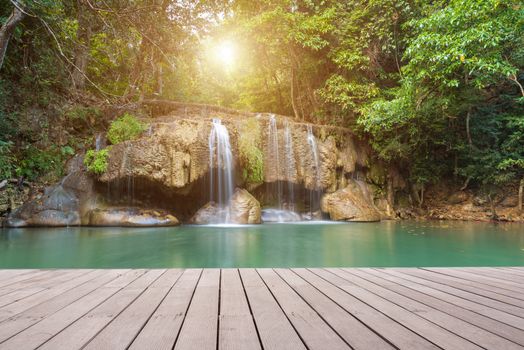 Wooden plank and background with Waterfall in Erawan Park