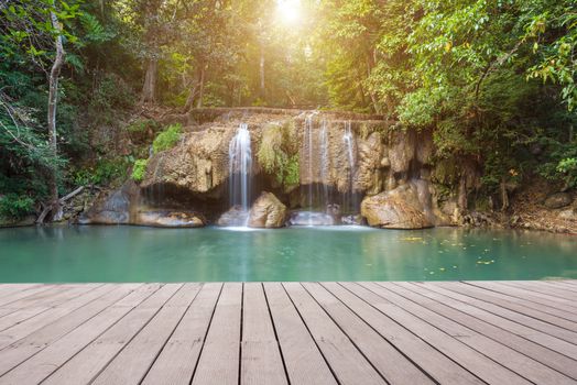 Wooden plank and background with Waterfall in Erawan Park