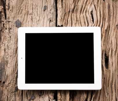 White Tablet pc on old wooden table